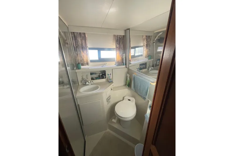 Slide: The Image of Bathroom interior of 1995 Carver 355 Aft Cabin Motor Yacht, featuring sink and toilet. - 30