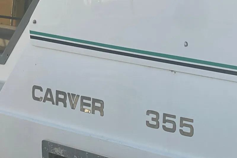 Slide: The Image of 1995 Carver 355 Aft Cabin Motor Yacht, white exterior with teal stripe. - 34