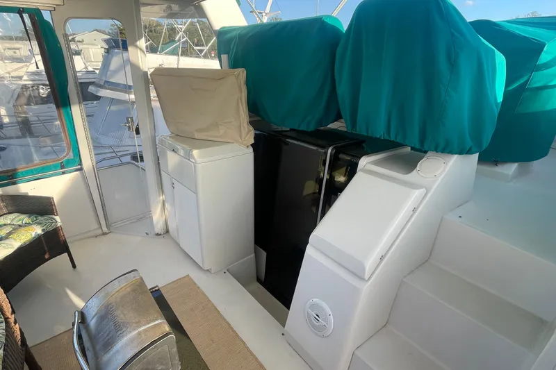 Slide: The Image of 1995 Carver 355 Aft Cabin Motor Yacht interior with covered seating and steps. - 8