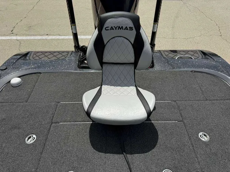 Slide: The Image of Caymas Bass CX 20 Pro 2025 seat on gray carpeted deck. - 24