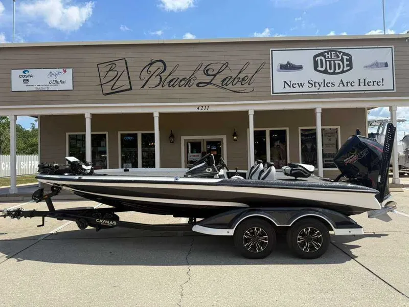 Slide: The Image of 2025 Caymas Bass CX 20 Pro parked in front of a store. - 9
