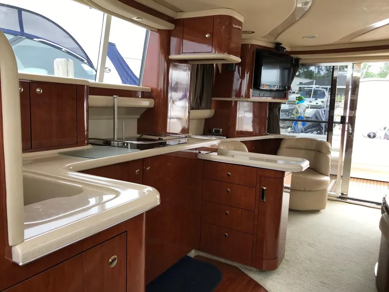 Slide: The Image of 2003 Sea Ray 480 Sedan Bridge helm with wood steering wheel. - 10