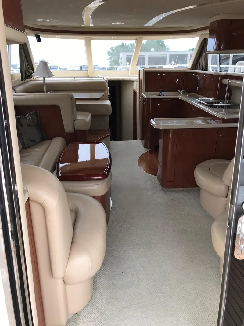Slide: The Image of Interior of 2003 Sea Ray 480 Sedan Bridge, elegant wood-finished kitchen. - 12
