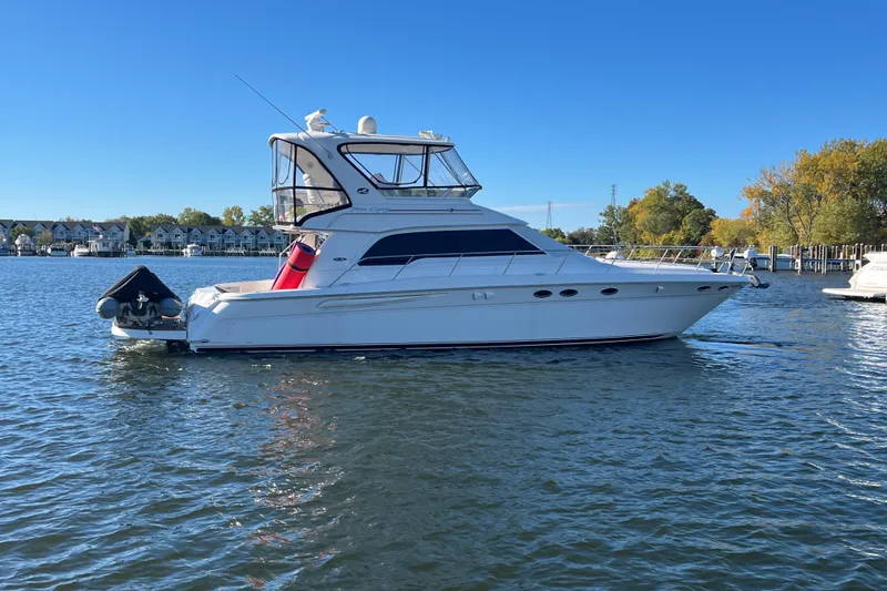 Slide: The Image of 2003 Sea Ray 480 Sedan Bridge yacht on calm water, clear blue sky background. - 31