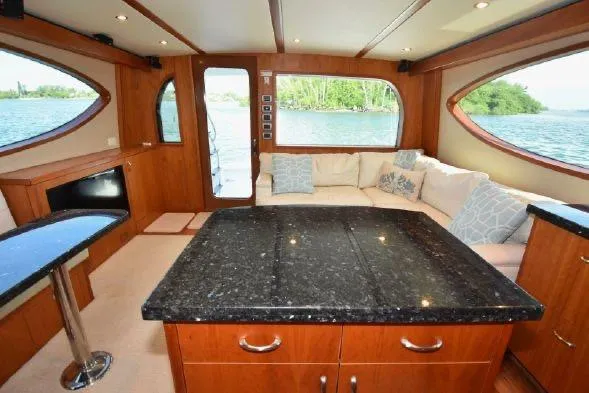 Slide: The Image of Luxurious bedroom interior of 2013 Hatteras GT54 yacht with elegant bedding and wood accents. - 10