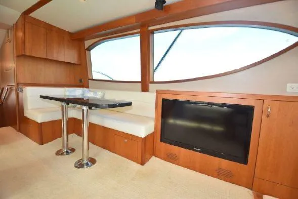 Slide: The Image of 2013 Hatteras GT54 cabin with twin beds and ocean-themed bedding. - 12