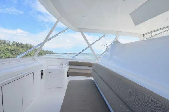 Slide: The Image of 2013 Hatteras GT54 yacht deck with seating, ladder, and ocean view. - 16