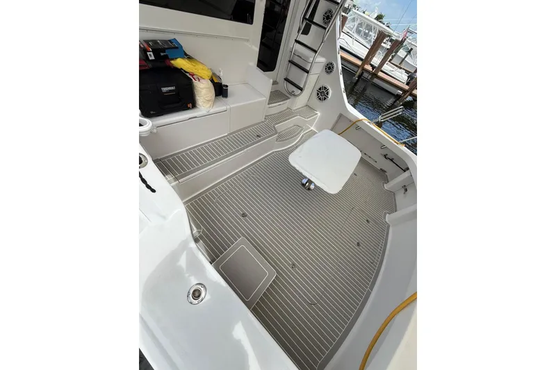 Slide: The Image of 2013 Hatteras GT54 yacht helm with ocean view and white captain chairs. - 20