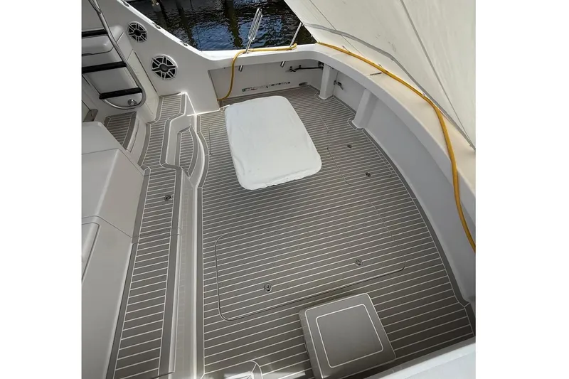 Slide: The Image of Spacious deck of 2013 Hatteras GT54 yacht with striped flooring and seating area. - 23