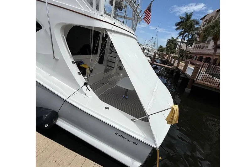 Slide: The Image of 2013 Hatteras GT54 yacht deck with table and fishing gear. - 26