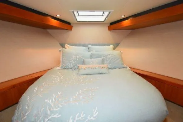 Slide: The Image of Luxurious 2013 Hatteras GT54 yacht kitchen with sleek wood cabinetry and black countertops. - 7