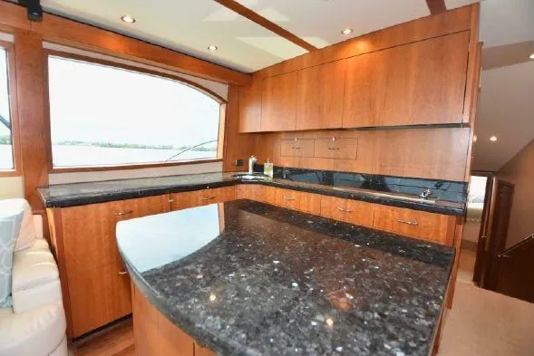 Slide: The Image of Luxurious interior of 2013 Hatteras GT54 yacht with wood cabinetry and seating. - 9