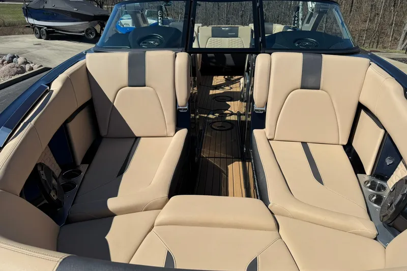 Slide: The Image of 2022 MasterCraft X24 boat interior with beige seating and wood flooring. - 7
