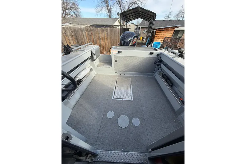 Slide: The Image of 2022 Hewescraft 220 Ocean Pro Hardtop boat interior with spacious deck and storage compartments. - 13