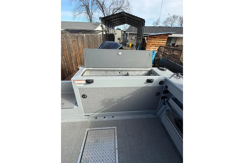 Slide: The Image of 2022 Hewescraft 220 Ocean Pro Hardtop boat interior with storage compartment. - 15