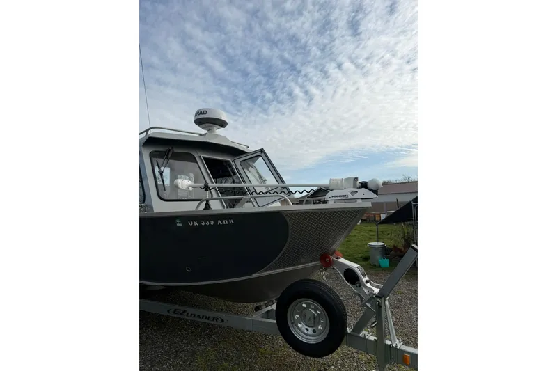 Slide: The Image of 2022 Hewescraft 220 Ocean Pro Hardtop boat on trailer under cloudy sky. - 19