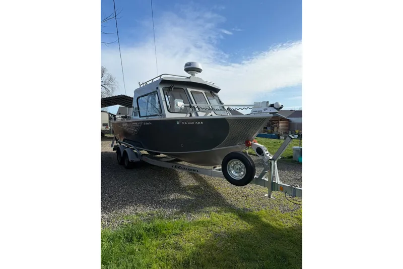 Slide: The Image of 2022 Hewescraft 220 Ocean Pro Hardtop boat on trailer, parked outdoors. - 2