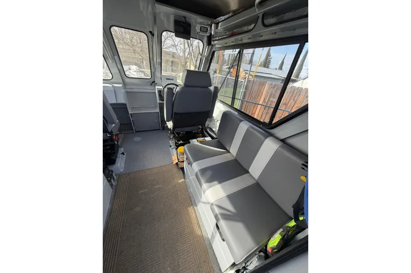 Slide: The Image of Interior of 2022 Hewescraft 220 Ocean Pro Hardtop, featuring seating and windows. - 3