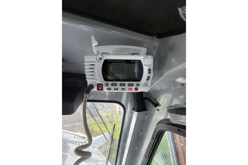 Slide: The Image of Radio equipment inside a 2022 Hewescraft 220 Ocean Pro Hardtop boat. - 7