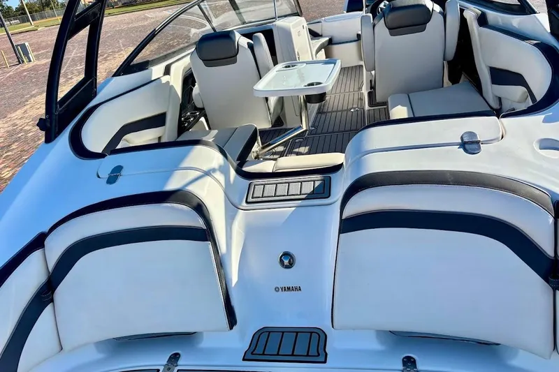 Slide: The Image of 2016 Yamaha Boats AR240 HO interior with seating and table, showcasing luxury and comfort. - 12