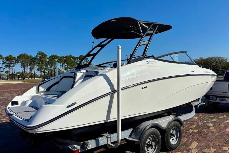 Slide: The Image of 2016 Yamaha Boats AR240 HO on trailer, sleek design, white exterior, sunny day. - 3