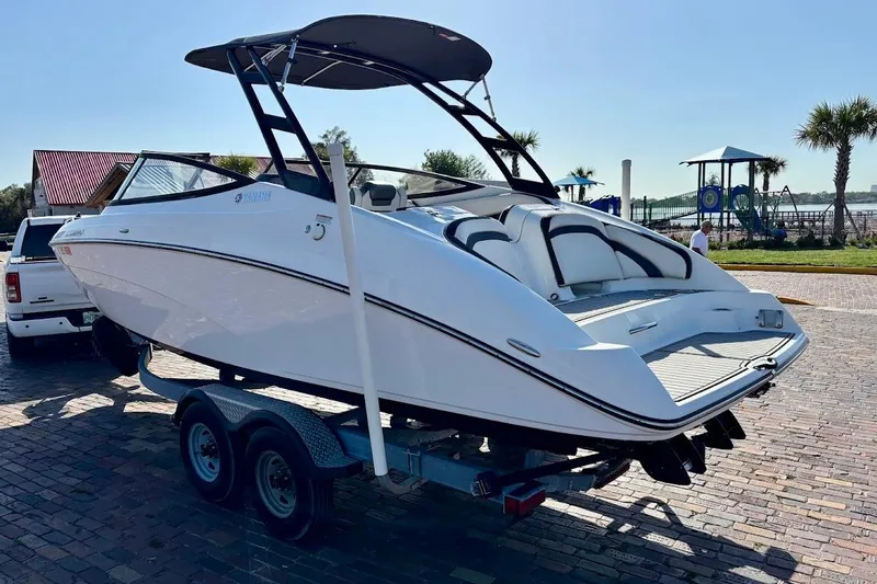 Slide: The Image of 2016 Yamaha Boats AR240 HO on trailer, sleek design, parked outdoors. - 4