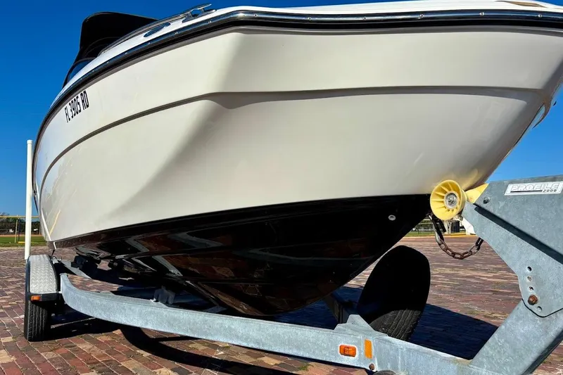 Slide: The Image of 2016 Yamaha Boats AR240 HO on trailer, close-up view of hull and trailer. - 7