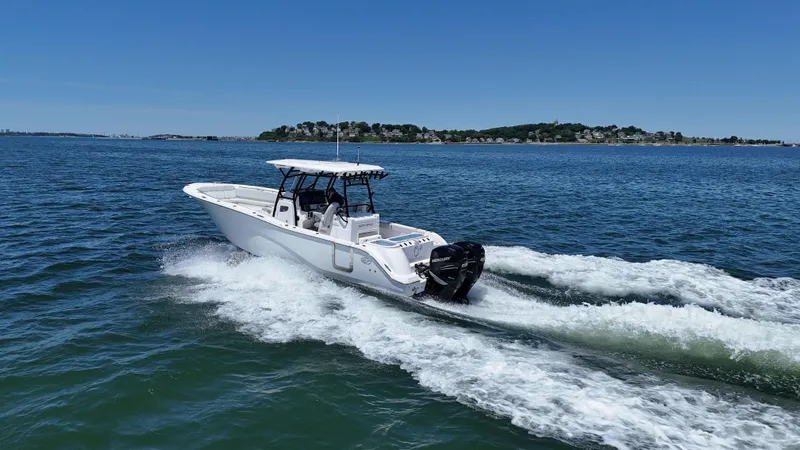 Slide: The Image of 2022 Sea Fox 328 Commander cruising on open water under clear blue skies. - 13