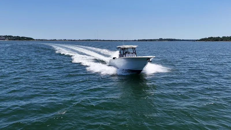 Slide: The Image of 2022 Sea Fox 328 Commander cruising on open water under clear blue skies. - 15