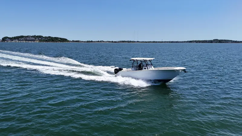 Slide: The Image of 2022 Sea Fox 328 Commander cruising on open water under clear blue sky. - 17