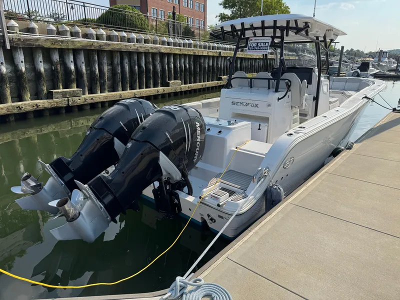 Slide: The Image of 2022 Sea Fox 328 Commander boat docked with dual outboard engines. - 20