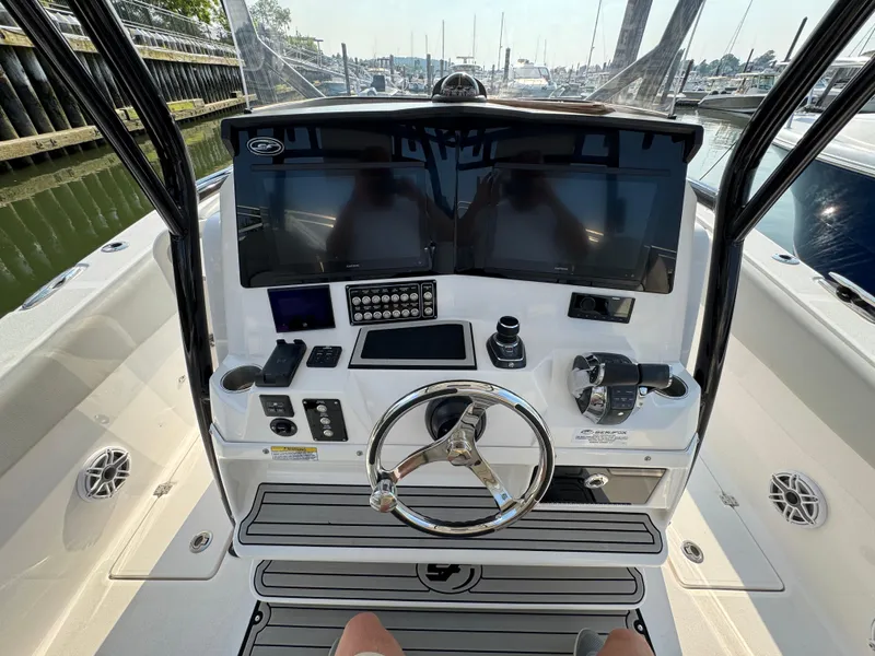 Slide: The Image of 2022 Sea Fox 328 Commander boat dashboard with dual screens and steering wheel. - 22
