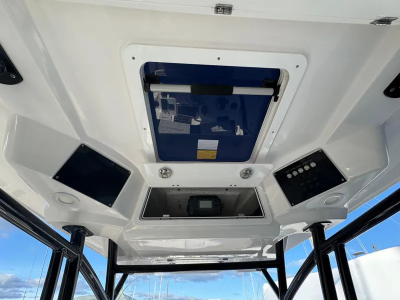 Slide: The Image of 2022 Sea Fox 328 Commander boat interior ceiling with control panels and hatch. - 24