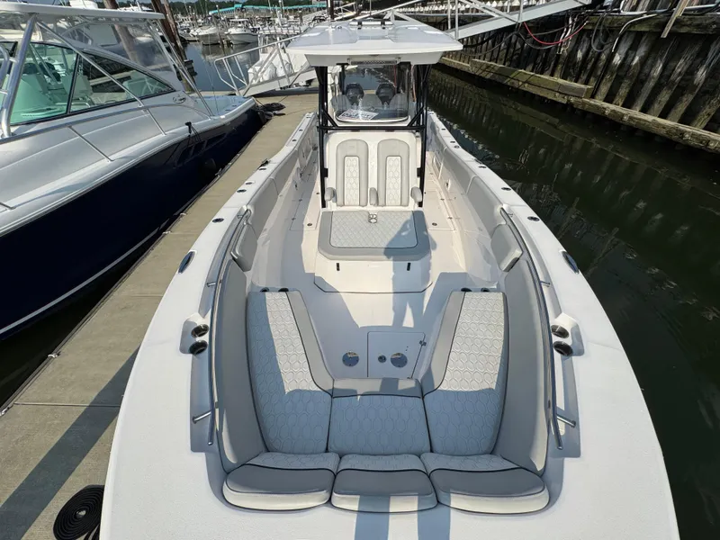 Slide: The Image of 2022 Sea Fox 328 Commander boat docked, featuring spacious seating and sleek design. - 26