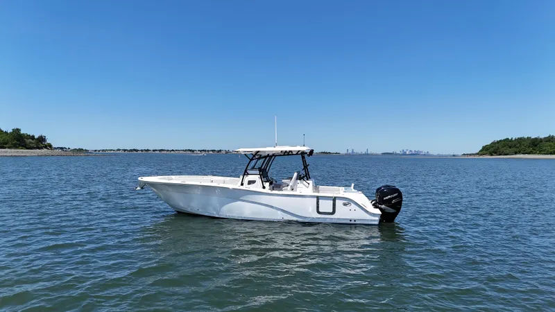 Slide: The Image of 2022 Sea Fox 328 Commander boat on calm water under clear blue sky. - 5