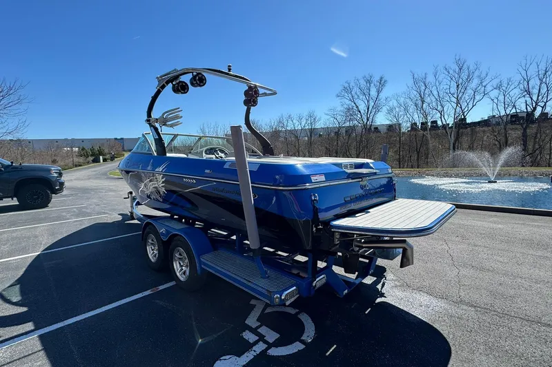 Slide: The Image of 2011 Centurion Avalanche C4 boat on trailer near fountain in parking lot. - 5