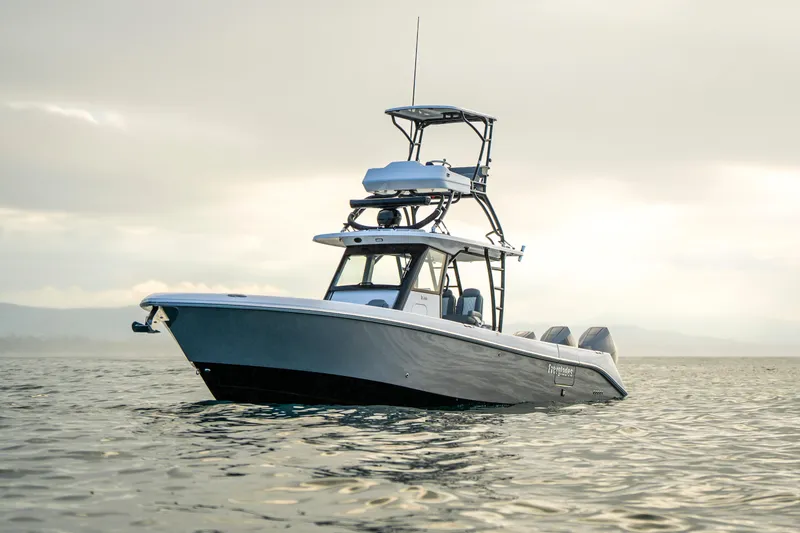 Slide: The Image of 2024 Everglades 365 Center Console boat on calm water under cloudy sky. - 10