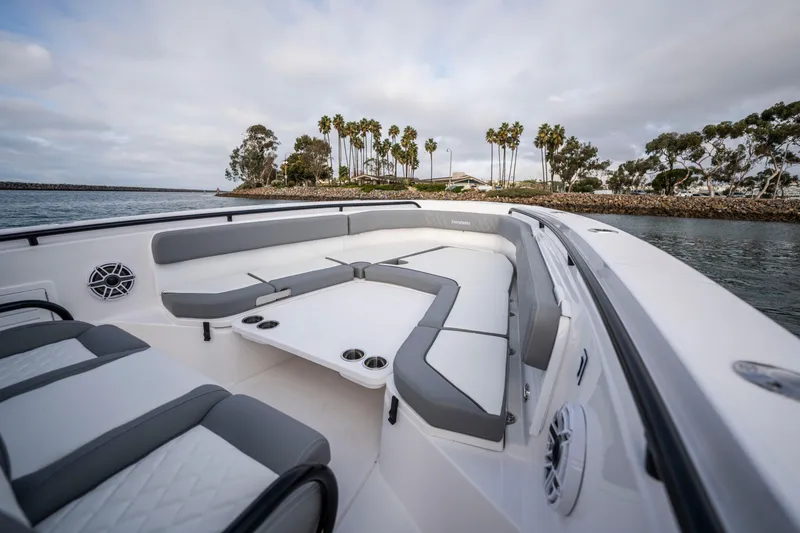 Slide: The Image of 2024 Everglades 365 Center Console boat interior with spacious seating and scenic water view. - 106