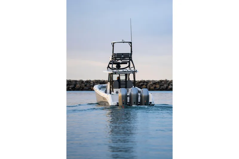 Slide: The Image of 2024 Everglades 365 Center Console boat on water, rear view with triple engines. - 11