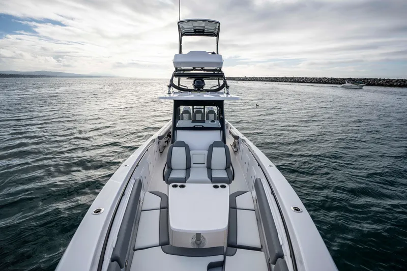 Slide: The Image of 2024 Everglades 365 Center Console boat on open water, showcasing sleek design and spacious seating. - 111