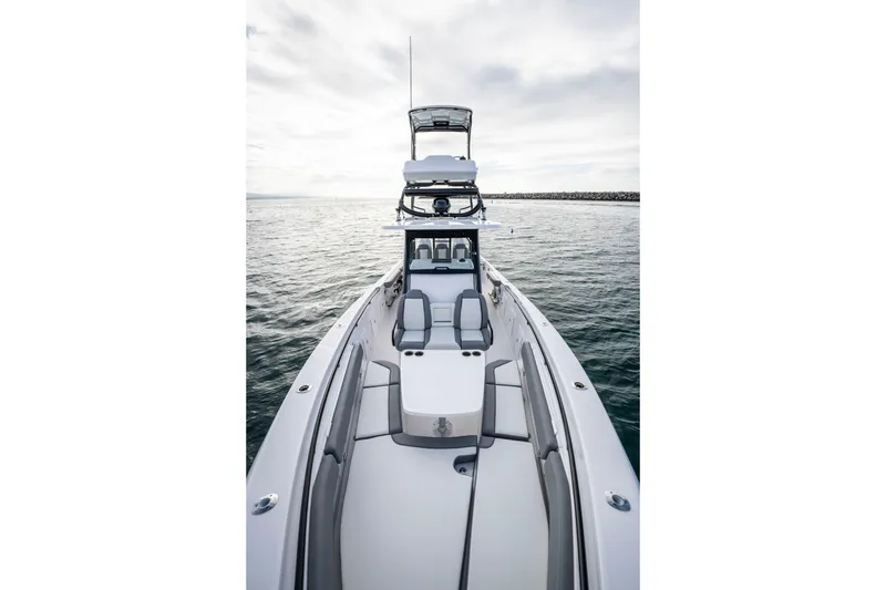 Slide: The Image of 2024 Everglades 365 Center Console boat on open water, showcasing sleek design and spacious deck. - 113