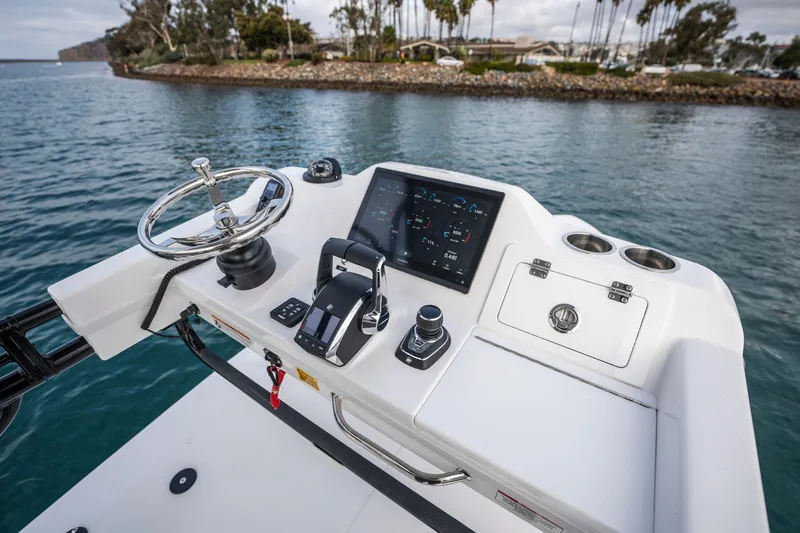 Slide: The Image of 2024 Everglades 365 Center Console helm with modern controls and digital display on water. - 115