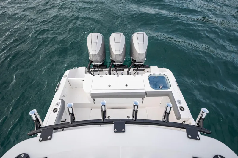 Slide: The Image of 2024 Everglades 365 Center Console boat with triple engines on open water. - 117