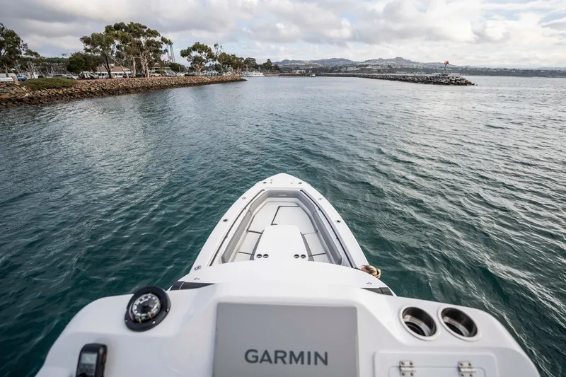 Slide: The Image of 2024 Everglades 365 Center Console boat navigating coastal waters, featuring Garmin technology. - 118