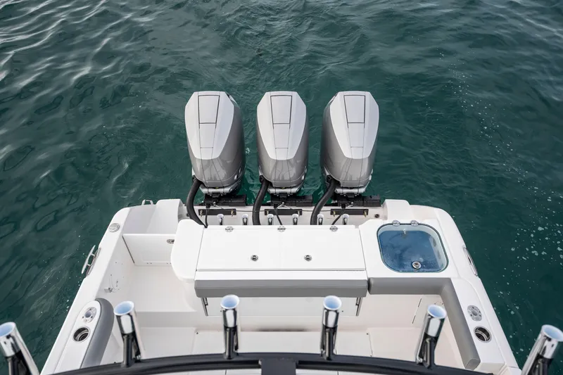 Slide: The Image of 2024 Everglades 365 Center Console with triple outboard engines on open water. - 119