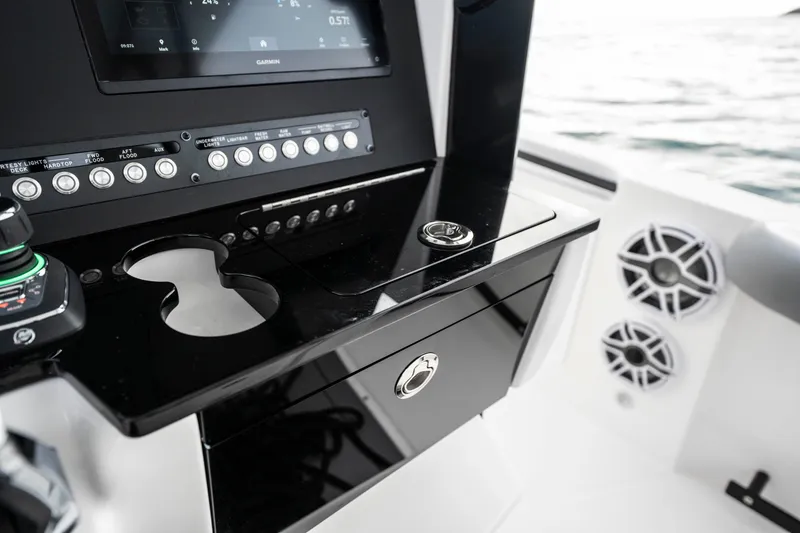 Slide: The Image of 2024 Everglades 365 Center Console dashboard with controls and speakers on a boat. - 122
