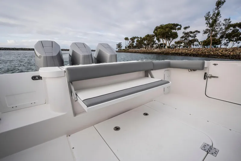 Slide: The Image of 2024 Everglades 365 Center Console boat with triple outboard engines, spacious deck, and seating. - 124