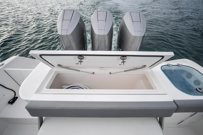 Slide: The Image of 2024 Everglades 365 Center Console boat with open storage and triple engines on water. - 125