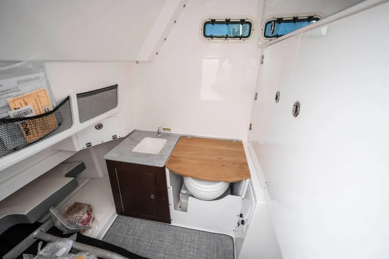 Slide: The Image of 2024 Everglades 365 Center Console cabin interior with sink and storage. - 126