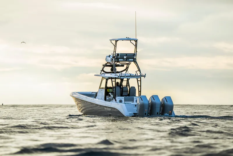 Slide: The Image of 2024 Everglades 365 Center Console boat on open water at sunset. - 13